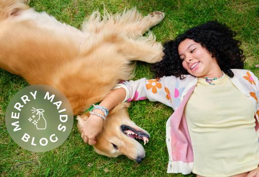 girl and dog in grass